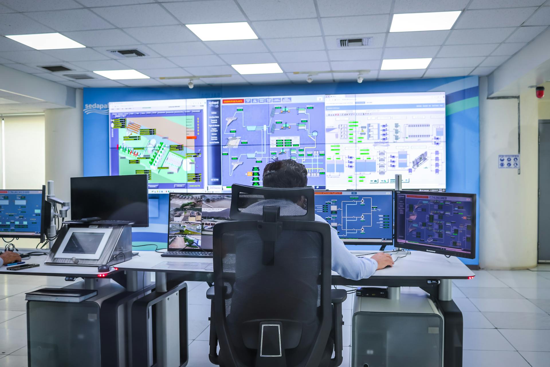 Mining operations control room with multiple monitors
