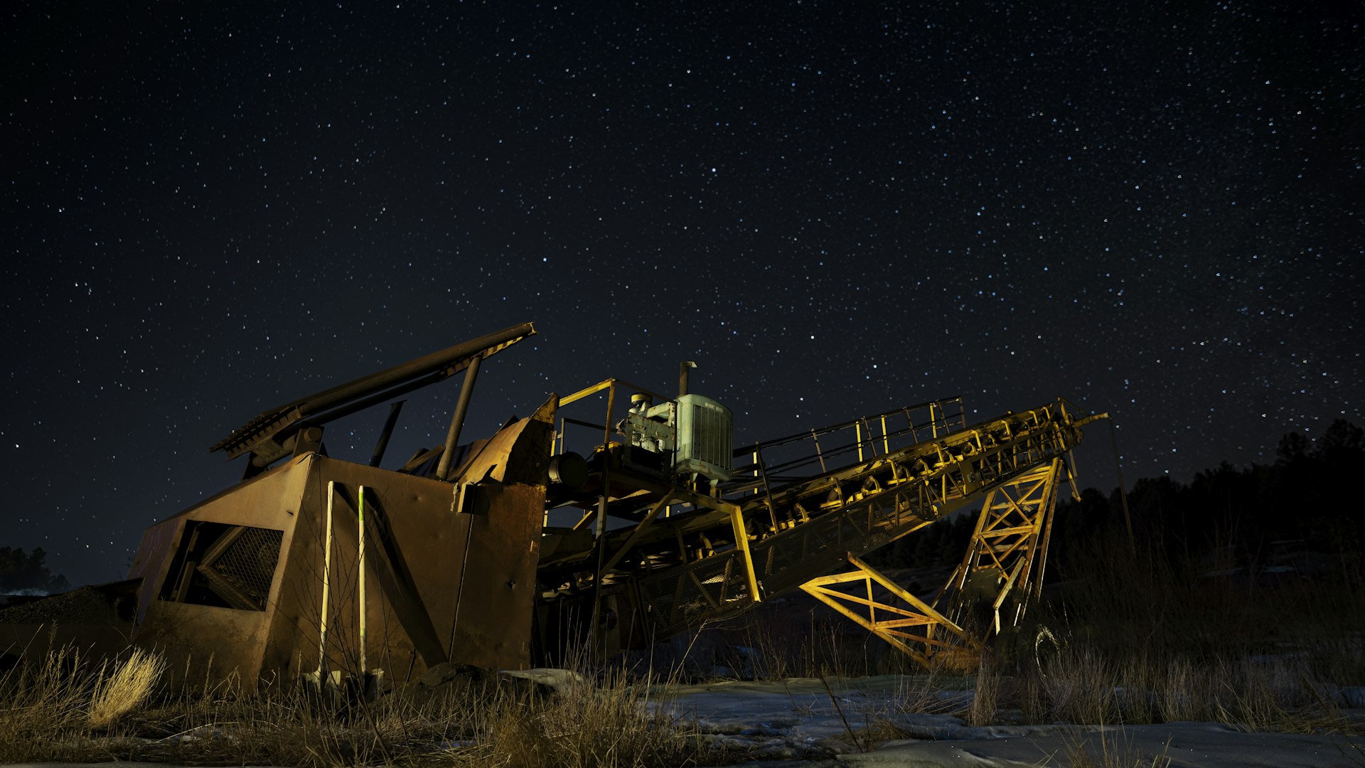 Mining operations at night with dramatic lighting